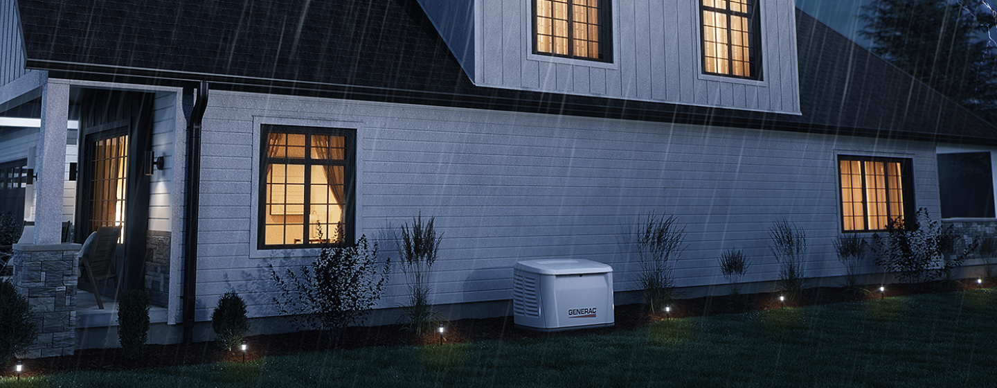 log home with lights on surrounded in snow on a starry night